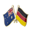 A pin badge featuring the flags of Australia and Germany in enamel with a gold-colored border and a butterfly clutch backing.