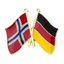 A badge featuring the flags of Norway and Germany with a butterfly clutch, primarily in red, black, yellow, and blue colors.