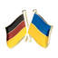 A friendship pin badge featuring the flag colors of Germany and Ukraine with a butterfly clutch.