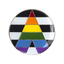 A round pin badge featuring a colorful geometric design resembling a triangle with the colors of the rainbow flag, and a butterfly clutch at the back.
