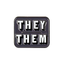 A square-shaped pin badge with 'THEY/THEM' text in bold, brass-plated iron with a butterfly clutch back. © Tigoli® 2026 All Rights Reserved Panda Loco Ltd