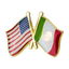 A pin badge featuring the United States and Mexico flags with a friendship symbol superimposed on them, against a white background.