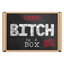 The image features a novelty gift product named "Bitch In a Box." It displays a simple yet striking design with bold, black text that reads "BITCH" in a large, capital letter, followed by "IN A 100% REAL BOX" in smaller text, emphasizing the product's authenticity. © Tigoli® 2026 All Rights Reserved Panda Loco Ltd