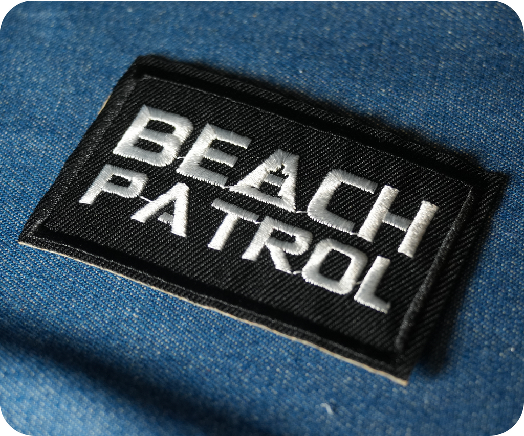 Beach Patrol Black Lifeguard Buoy Iron On Patch (7.8 x 5cm)