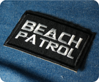 Beach Patrol Black Lifeguard Buoy Iron On Patch (7.8 x 5cm)