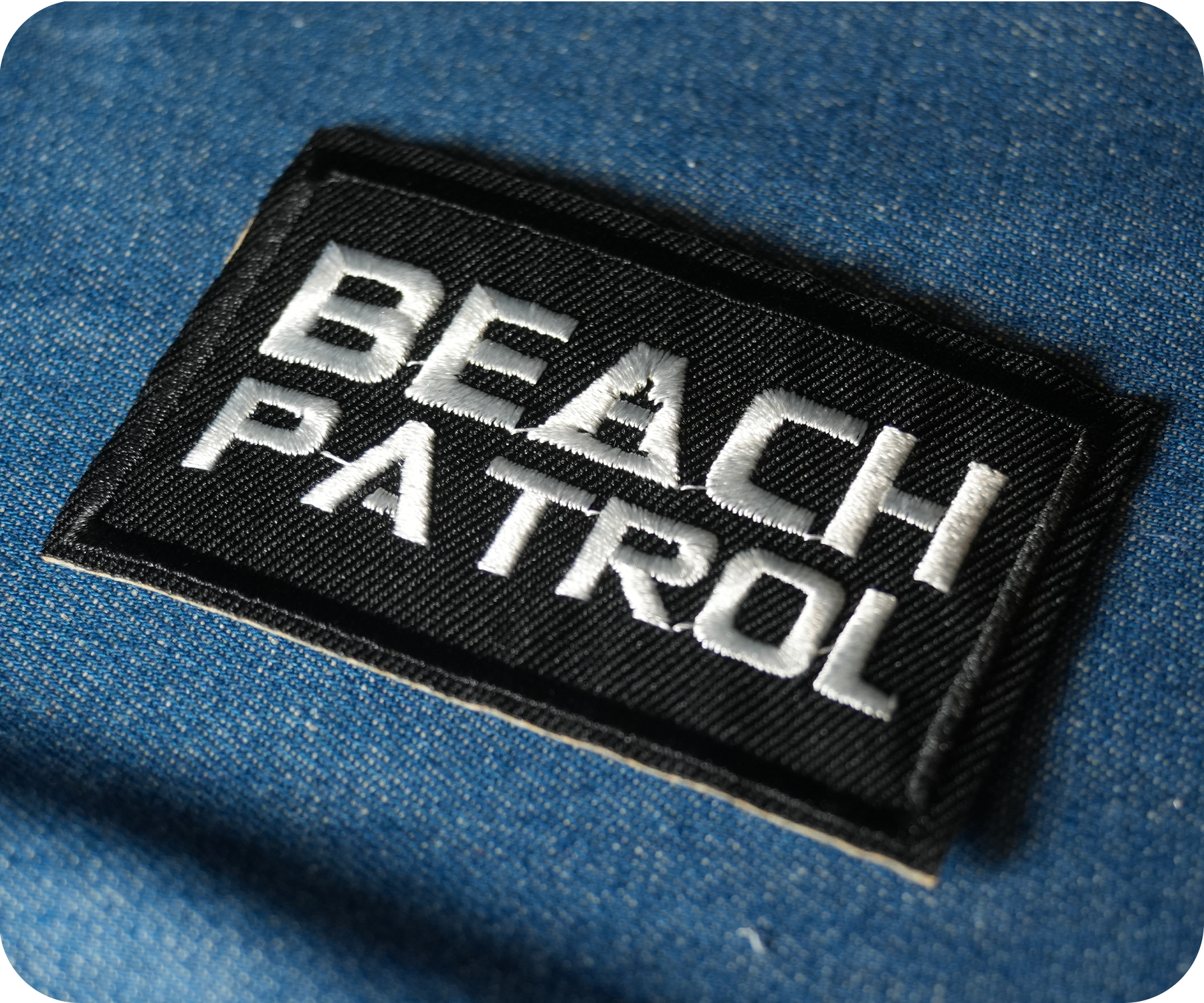 Beach Patrol Black Lifeguard Buoy Iron On Patch (7.8 x 5cm)