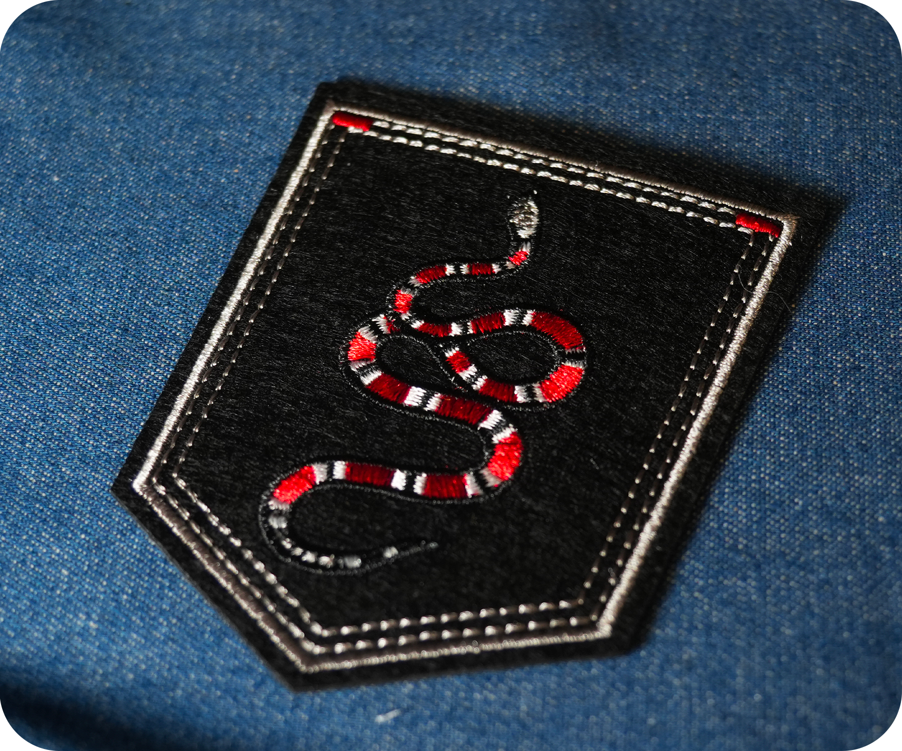 Coral Snake On Black Shield Iron On Patch (9 x 7.6cm)