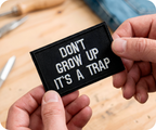 Don't Grow Up It's A Trap Black Iron On Patch (7.8 x 5cm)