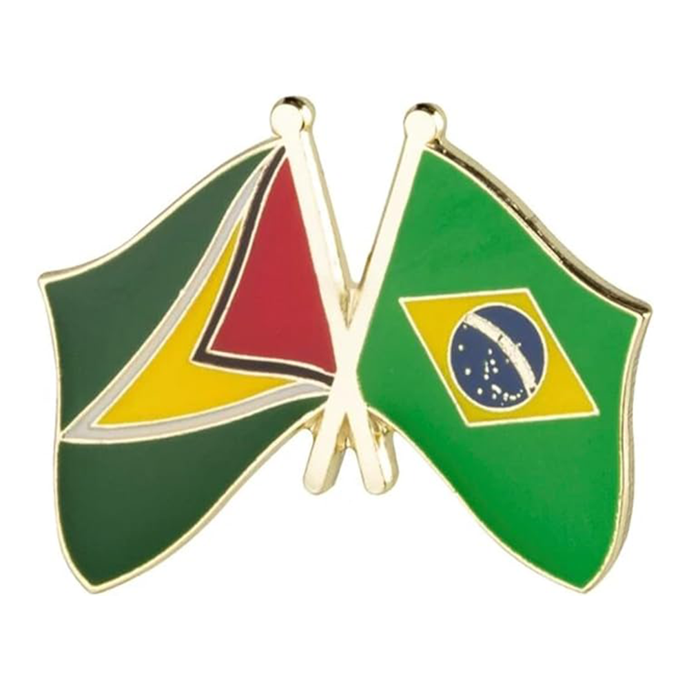 A pin badge featuring the flags of Guyana and Brazil with a butterfly clutch backing, made from brass plated iron and hard enamel.