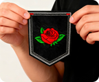 Red Rose Bud Flower Shield Black Iron On Patch (9 x 7.6cm)