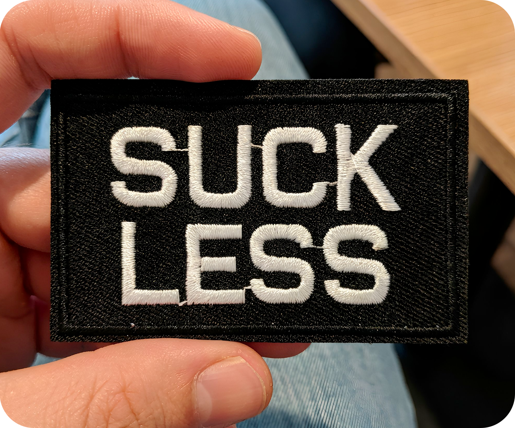 Suck Less Black Iron On Patch (7.8 x 5cm)