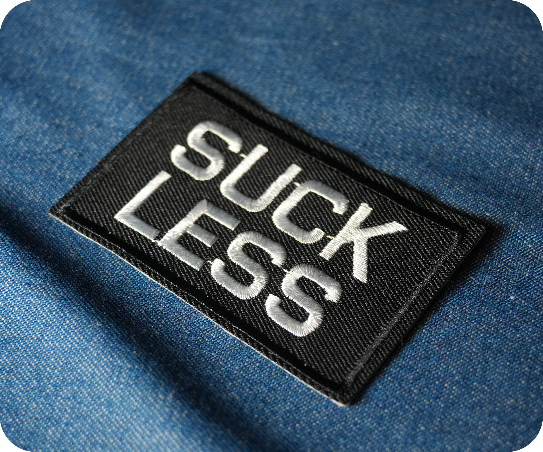 Suck Less Black Iron On Patch (7.8 x 5cm)