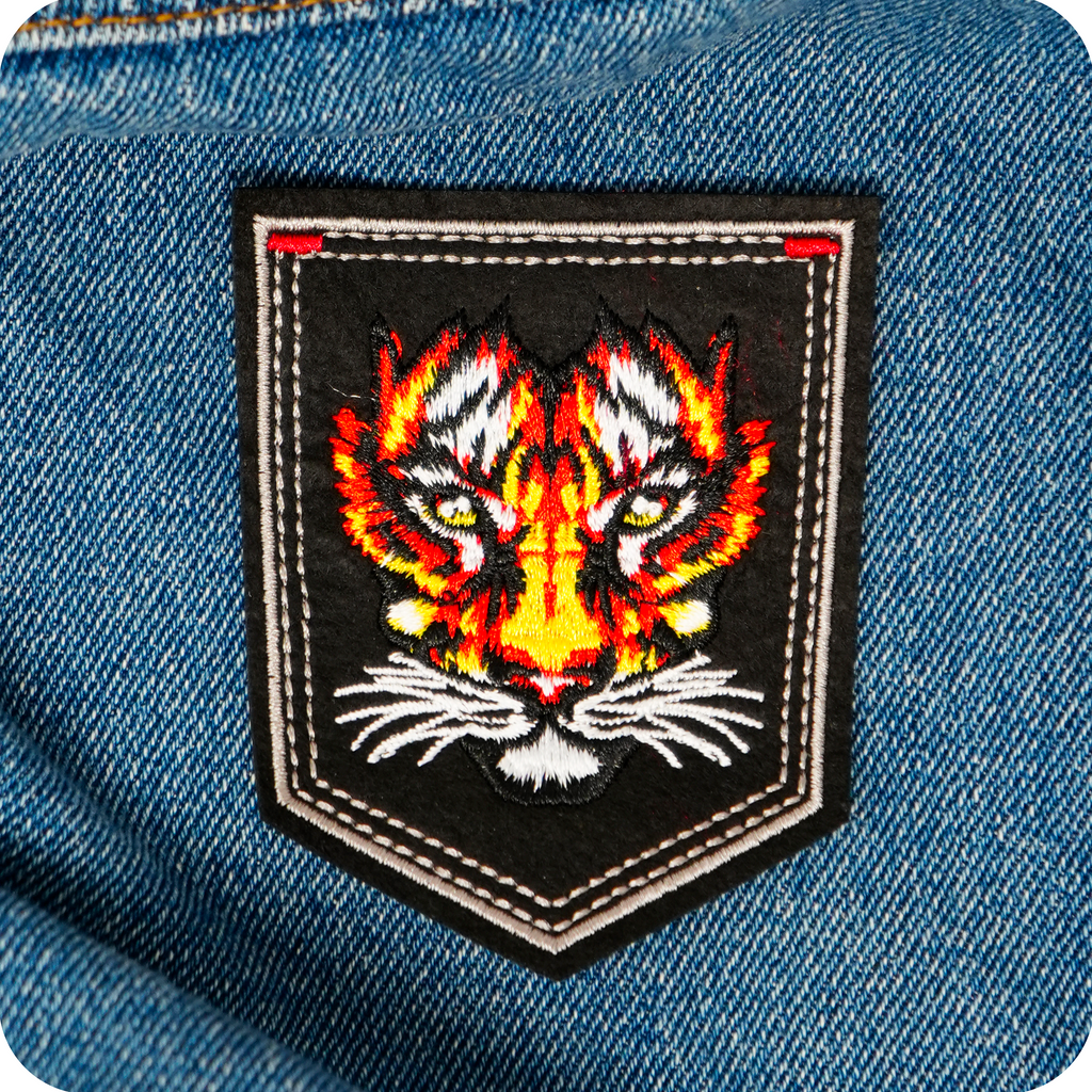 Tiger Face On Black Shield Iron On Patch (9 x 7.6cm)
