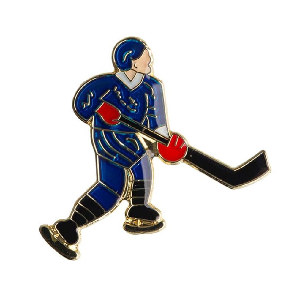 A pin badge depicting a blue ice hockey player with a black stick and red gloves.