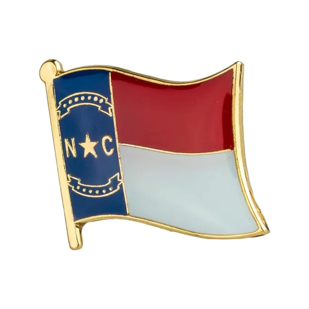 A brass plated iron pin badge shaped like the North Carolina flag, featuring the state's seal and colors.