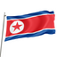 The flag of North Korea, featuring a red and blue stripe with a white star in the center, is shown waving on a flagpole.