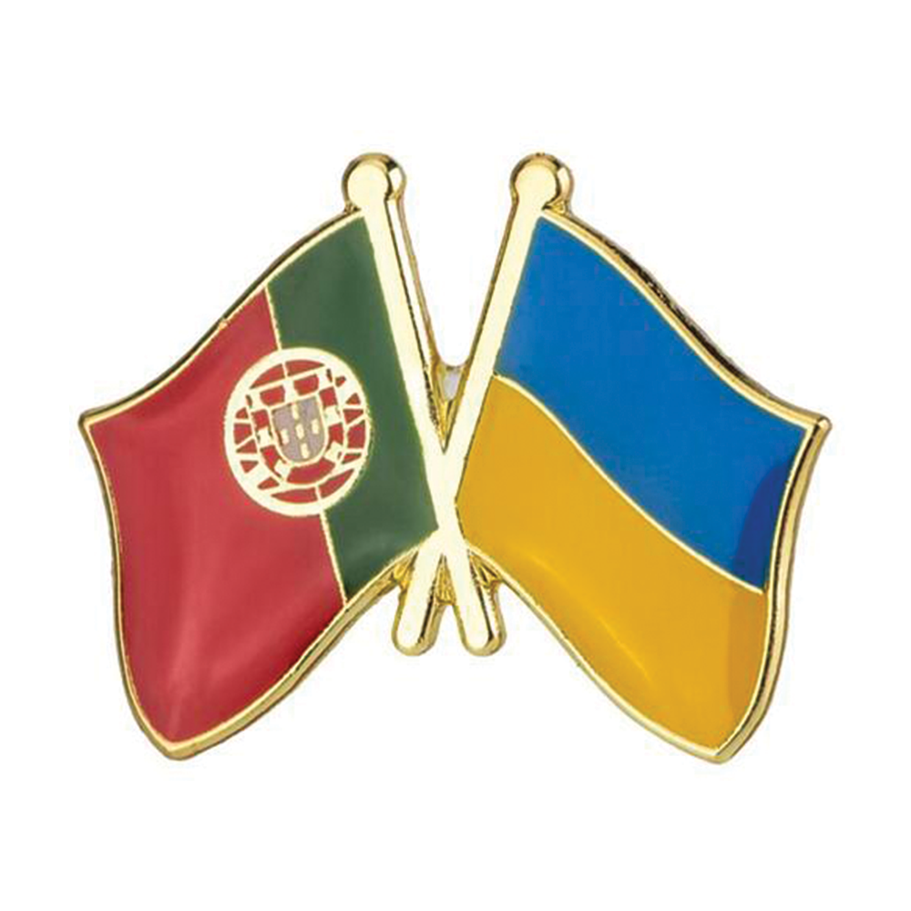 A friendship pin badge featuring the flags of Portugal and Ukraine with a butterfly clutch, primarily in gold, red, green, and blue colors. © Tigoli® 2026 All Rights Reserved Panda Loco Ltd 