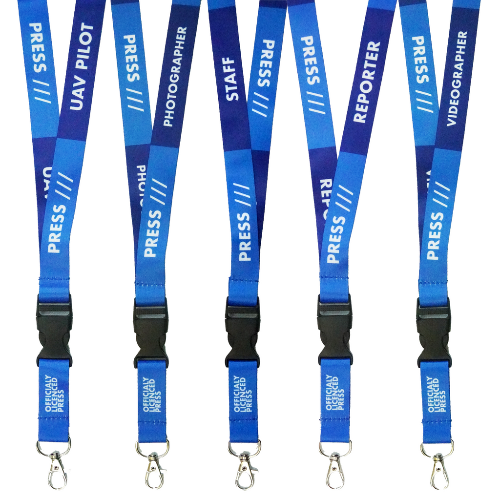 A collection of blue press lanyards with various job role texts printed on them, including 'PRESS', 'PHOTOGRAPHER', 'STAFF', and 'REPORTER'. They feature a black plastic buckle and are detachable.