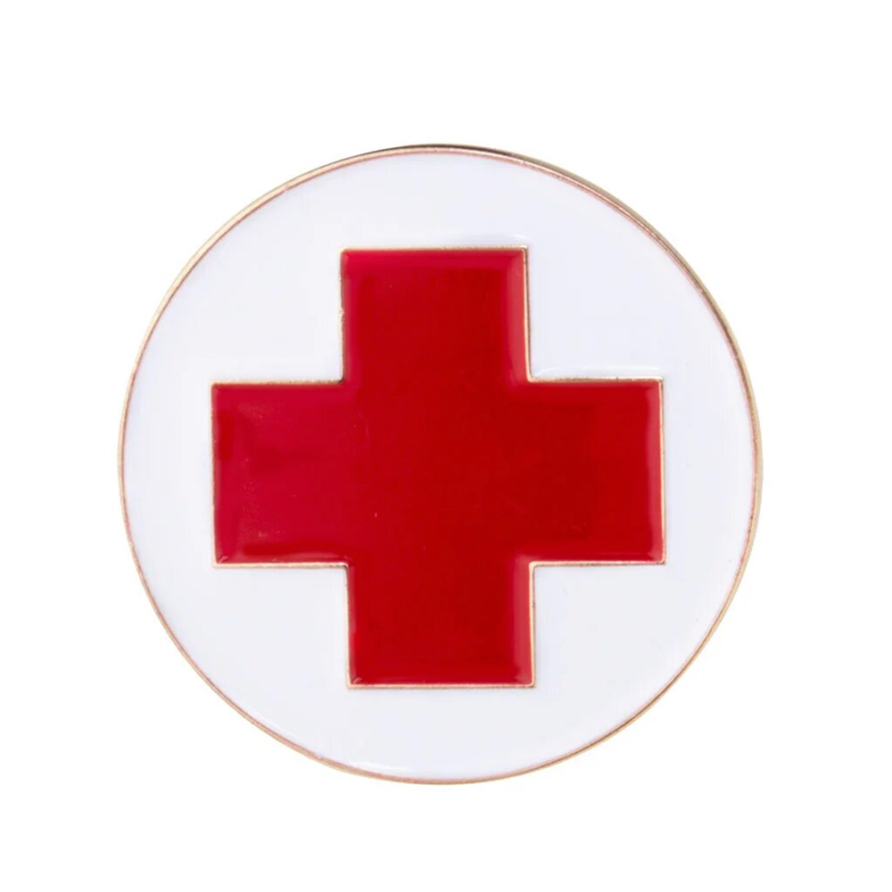 A round pin badge featuring a red cross medical emblem with a white border and red detailing on a white background.
