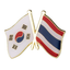 A badge featuring the flags of South Korea and Thailand with a butterfly clutch. © Tigoli® 2026 All Rights Reserved Panda Loco Ltd 