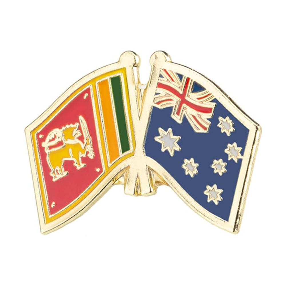 A brass plated iron and hard enamel pin badge featuring the flags of Sri Lanka and Australia, with a butterfly clutch backing.