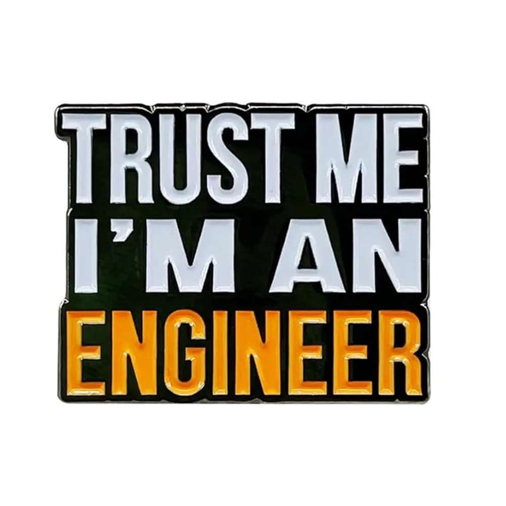 A pin badge with the text 'TRUST ME I'M AN ENGINEER' in capital letters, black and orange in color, on a flat background. Imagen principal del producto
