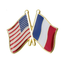 A friendship pin badge featuring crossed American and French flags, with a butterfly clutch for attachment. © Tigoli® 2026 All Rights Reserved Panda Loco Ltd 