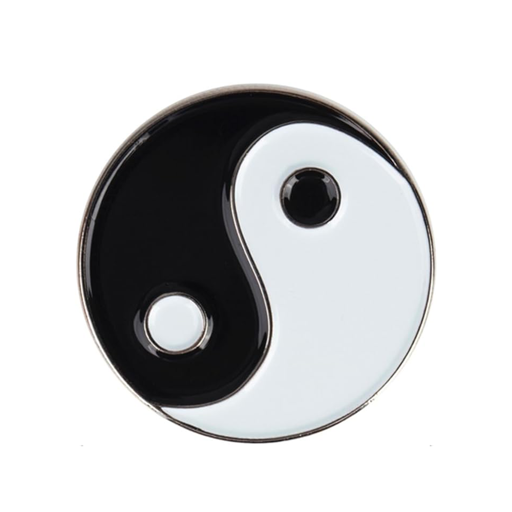 A round pin badge featuring the Ying & Yang symbol in black and white.