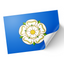A sticker depicting the Yorkshire Rose flag on a blue background with a peeled corner, indicating a adhesive surface.