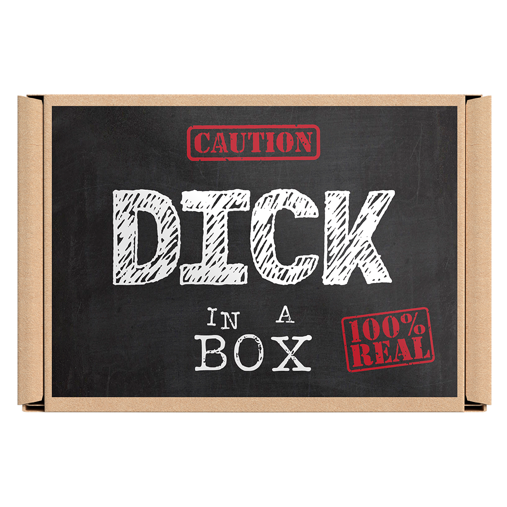 The image displays the packaging of the novelty gift item "Dick In a Box." The box, with a simplistic and bold design, features a chalkboard-style background with the humorous text "CAUTION: DICK IN A BOX REAL" highlighted in red. © Tigoli® 2026 All Rights Reserved Panda Loco Ltd  Imagen principal del producto