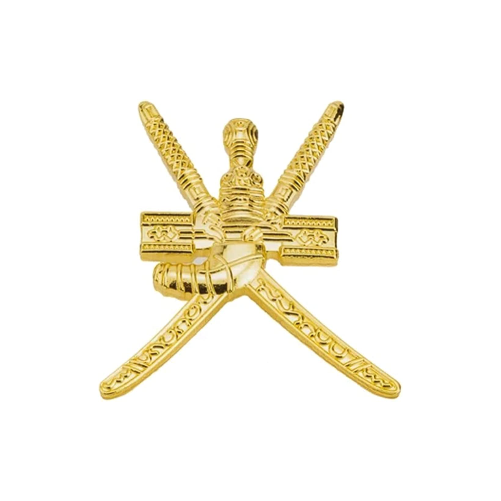 A gold-colored pin badge featuring crossed swords, likely made from brass-plated iron, with a butterfly clutch backing. © Tigoli® 2026 All Rights Reserved Panda Loco Ltd 