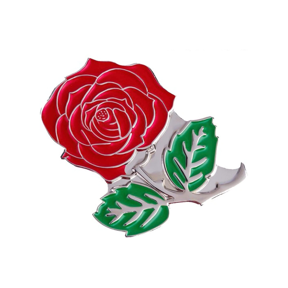 A pin badge featuring a red rose with green leaves, made of brass plated iron with hard enamel finish. © Tigoli® 2026 All Rights Reserved Panda Loco Ltd  Imagen principal del producto